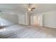 Large bonus room featuring neutral walls, tray ceiling, and ceiling fan at 100 Bree Dr, Fayetteville, GA 30214