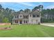 Beautiful new construction home featuring a manicured lawn and a mix of stone and siding exterior at 100 Bree Dr, Fayetteville, GA 30214
