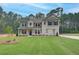 Beautiful new construction home featuring a manicured lawn and a mix of stone and siding exterior at 100 Bree Dr, Fayetteville, GA 30214