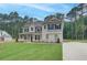 New construction home with manicured lawn and a mix of stone and siding with a side-entry garage at 100 Bree Dr, Fayetteville, GA 30214