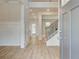 Bright foyer featuring an open floor plan, decorative trim, wood floors, and a staircase at 100 Bree Dr, Fayetteville, GA 30214