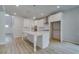 Bright kitchen features white cabinets, stainless steel appliances, and an island with pendant lighting at 100 Bree Dr, Fayetteville, GA 30214