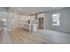 Open-concept kitchen featuring white cabinets, a central island and modern appliances, bathed in natural light at 100 Bree Dr, Fayetteville, GA 30214