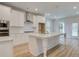 Bright kitchen features white cabinets, stainless steel appliances, and an island with pendant lighting at 100 Bree Dr, Fayetteville, GA 30214