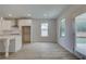 Modern kitchen area with white cabinets, stainless appliances, eat in kitchen and lots of natural light at 100 Bree Dr, Fayetteville, GA 30214