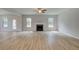 Spacious living room with natural light features a cozy fireplace and access to the outdoors at 100 Bree Dr, Fayetteville, GA 30214