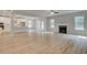 Open concept living room and kitchen with hardwood flooring, fireplace and large windows for natural light at 100 Bree Dr, Fayetteville, GA 30214