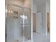 Modern bathroom with a glass-enclosed shower and sleek fixtures, plus a view into the toilet room at 100 Bree Dr, Fayetteville, GA 30214
