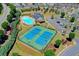 Community aerial view showcasing tennis courts, pool, clubhouse, parking, and landscaping in a residential neighborhood at 1345 Aster Ives Dr, Lawrenceville, GA 30045