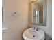 Bathroom vanity with a round mirror and small sink at 1345 Aster Ives Dr, Lawrenceville, GA 30045