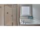 Well-lit bathroom features a glass-enclosed shower and a relaxing soaking tub with a view at 1345 Aster Ives Dr, Lawrenceville, GA 30045