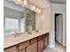 Bathroom with double sink vanity, framed mirror, and a view into the toilet room at 1345 Aster Ives Dr, Lawrenceville, GA 30045