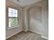 Cozy bedroom featuring plush carpet, a window, and an arched alcove at 1345 Aster Ives Dr, Lawrenceville, GA 30045