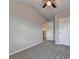 Cozy bedroom featuring plush carpet, a ceiling fan, and ample closet space at 1345 Aster Ives Dr, Lawrenceville, GA 30045