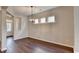 Dining area featuring modern light fixture, hardwood floors, and an open floor plan concept at 1345 Aster Ives Dr, Lawrenceville, GA 30045