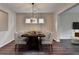 Elegant dining room featuring modern light fixture, dining table with seating for eight, and three windows at 1345 Aster Ives Dr, Lawrenceville, GA 30045
