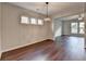 Dining area featuring stylish light fixture, three windows and hardwood floors at 1345 Aster Ives Dr, Lawrenceville, GA 30045