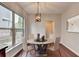 Bright dining room with a round table, modern chairs, and a large window at 1345 Aster Ives Dr, Lawrenceville, GA 30045