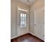 Bright entryway with a stylish front door with glass inserts, a side lite window, and dark wood floors at 1345 Aster Ives Dr, Lawrenceville, GA 30045