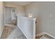 Upstairs hallway with neutral tones, offering a bright and airy transition between rooms at 1345 Aster Ives Dr, Lawrenceville, GA 30045