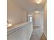 A bright upstairs hallway with plush carpeting and neutral paint provides a serene and inviting space at 1345 Aster Ives Dr, Lawrenceville, GA 30045