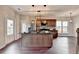 Spacious kitchen with stainless steel appliances, center island, and wood flooring at 1345 Aster Ives Dr, Lawrenceville, GA 30045
