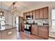 Well-lit kitchen featuring dark wood cabinetry, stainless steel appliances, and center island at 1345 Aster Ives Dr, Lawrenceville, GA 30045