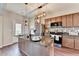Bright kitchen with a center island, stainless steel appliances, and dark wood cabinets at 1345 Aster Ives Dr, Lawrenceville, GA 30045