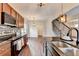 Open kitchen area with dark cabinets and stainless-steel appliances at 1345 Aster Ives Dr, Lawrenceville, GA 30045