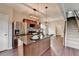 Modern kitchen with stainless steel appliances, granite countertops, and a center island with pendant lighting at 1345 Aster Ives Dr, Lawrenceville, GA 30045