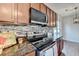 Kitchen cabinets with granite countertops and stainless-steel oven and microwave at 1345 Aster Ives Dr, Lawrenceville, GA 30045