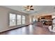 Open living area with hardwood floors, bright natural light, kitchen with stainless appliances, and a cozy stairwell at 1345 Aster Ives Dr, Lawrenceville, GA 30045