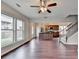 Spacious living area showcasing hardwood floors, large windows, and access to a modern kitchen at 1345 Aster Ives Dr, Lawrenceville, GA 30045