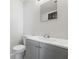 This half-bathroom has a modern vanity with a gray cabinet and an elegant white countertop at 213 Yuba Walk, Lawrenceville, GA 30046
