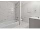 Bathroom featuring modern fixtures, a bathtub, and elegant white and gray marble-patterned tile surround at 213 Yuba Walk, Lawrenceville, GA 30046