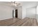 Spacious bedroom with wood floors, a ceiling fan, and an open door to another room at 213 Yuba Walk, Lawrenceville, GA 30046