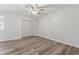 A bright bedroom featuring wood floors, a ceiling fan, and a closet at 213 Yuba Walk, Lawrenceville, GA 30046