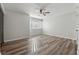 Bright bedroom boasts wood floors, a ceiling fan, and plenty of natural light from the window at 213 Yuba Walk, Lawrenceville, GA 30046