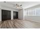 Spacious bedroom with ceiling fan, beautiful hardwood floors, and natural light from large windows at 213 Yuba Walk, Lawrenceville, GA 30046