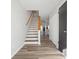 Home entryway featuring hardwood floors, stairs leading upstairs, and white neutral paint at 213 Yuba Walk, Lawrenceville, GA 30046