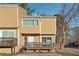 Two-story townhouse with a front porch, tan siding, and well-kept landscaping at 213 Yuba Walk, Lawrenceville, GA 30046