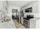 Well-lit kitchen with stainless steel appliances, granite counters, and gray modern cabinets at 213 Yuba Walk, Lawrenceville, GA 30046