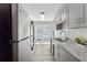 Modern kitchen with stainless steel appliances, gray cabinets, and granite countertops at 213 Yuba Walk, Lawrenceville, GA 30046