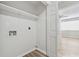 Utility room with new floors that has washer and dryer hookups and overhead shelving at 213 Yuba Walk, Lawrenceville, GA 30046