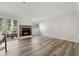 A spacious living room featuring wood floors, a brick fireplace, and a sliding glass door to the outside at 213 Yuba Walk, Lawrenceville, GA 30046