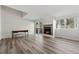 Spacious living room featuring wood floors, a brick fireplace, and a large window at 213 Yuba Walk, Lawrenceville, GA 30046