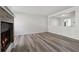 An airy living room featuring wood floors, a brick fireplace, and a pass-through to the kitchen at 213 Yuba Walk, Lawrenceville, GA 30046
