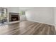 Bright living room featuring wood floors, a brick fireplace, and a sliding glass door to the outside at 213 Yuba Walk, Lawrenceville, GA 30046