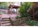 Backyard features a covered pavilion, stone retaining walls, and mature landscaping at 3572 Dexter Way, Marietta, GA 30062