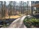 Backyard features a brick pathway, mature trees, lush foliage, and privacy at 3572 Dexter Way, Marietta, GA 30062